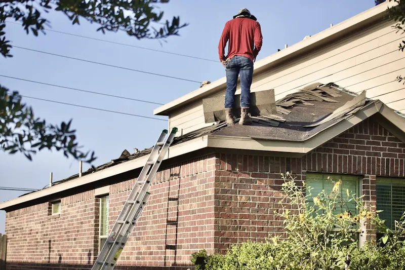 Professional roofer working on a residential roof in Bushkill Center